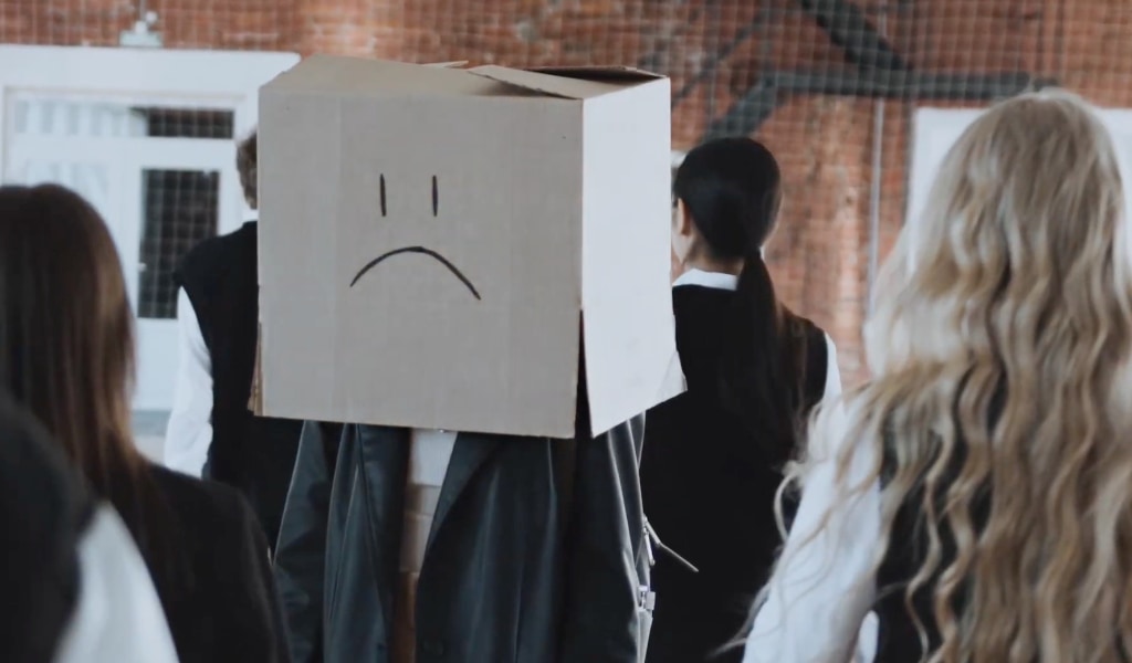 A person with a box on their head.