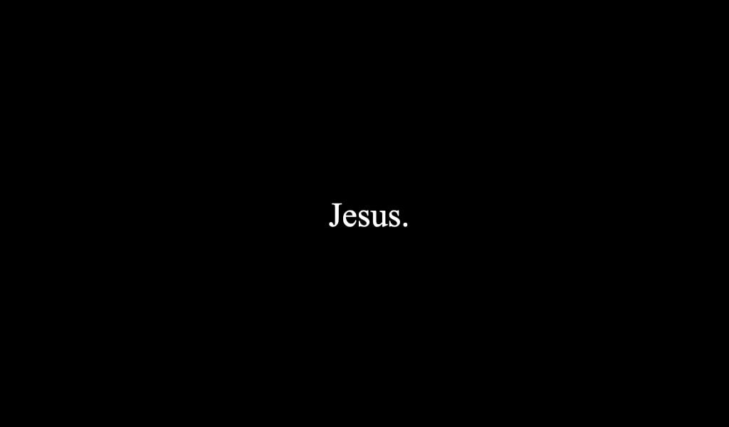 The word Jesus on a black background.
