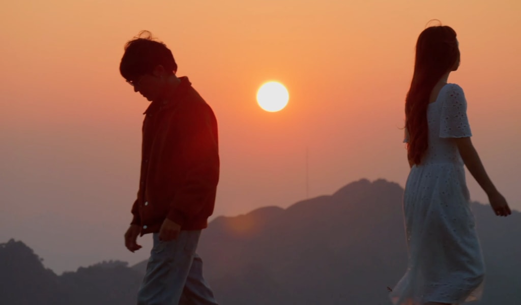 Two people walking away from each other.