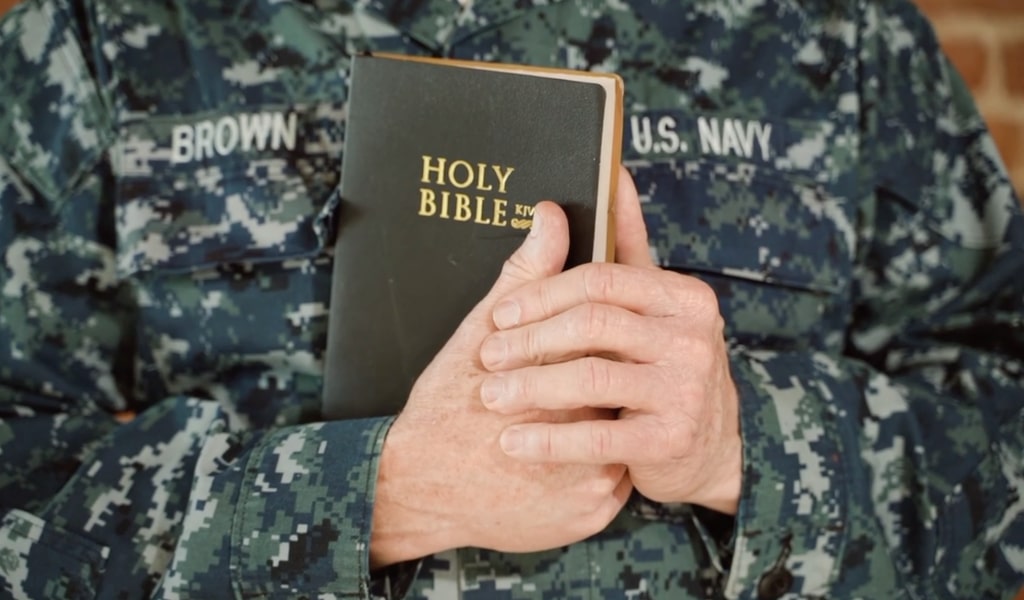 I Don't Believe in the Bible. Navy officer holding a Bible.